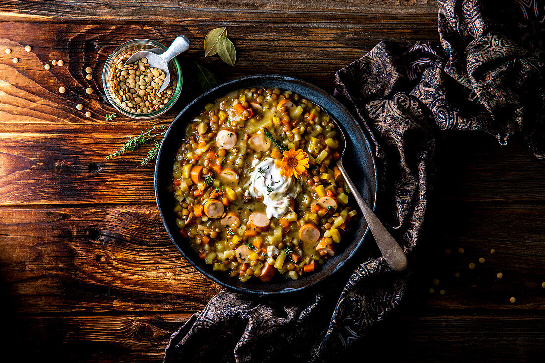 Grandma's lentil stew with bacon, root vegetables and sausages