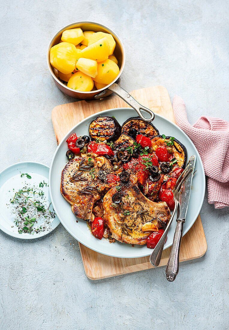 Pork chops with grilled aubergine and tomato ragout