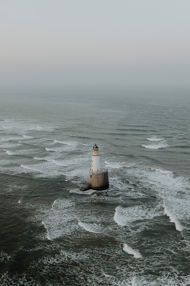 Aerial view waves around lighthouse on sea, Rattray, Aberdeenshire, Scotland\n