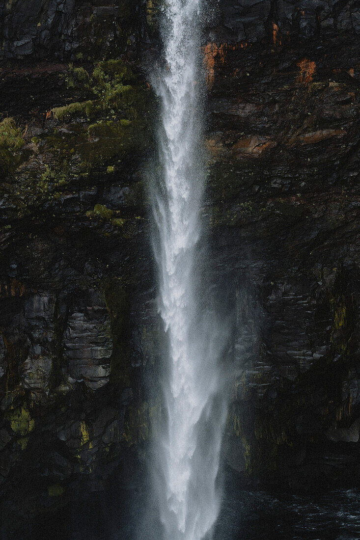 Waterfall flowing over cliff, Gasadalur, Vagar, Faroe Islands\n
