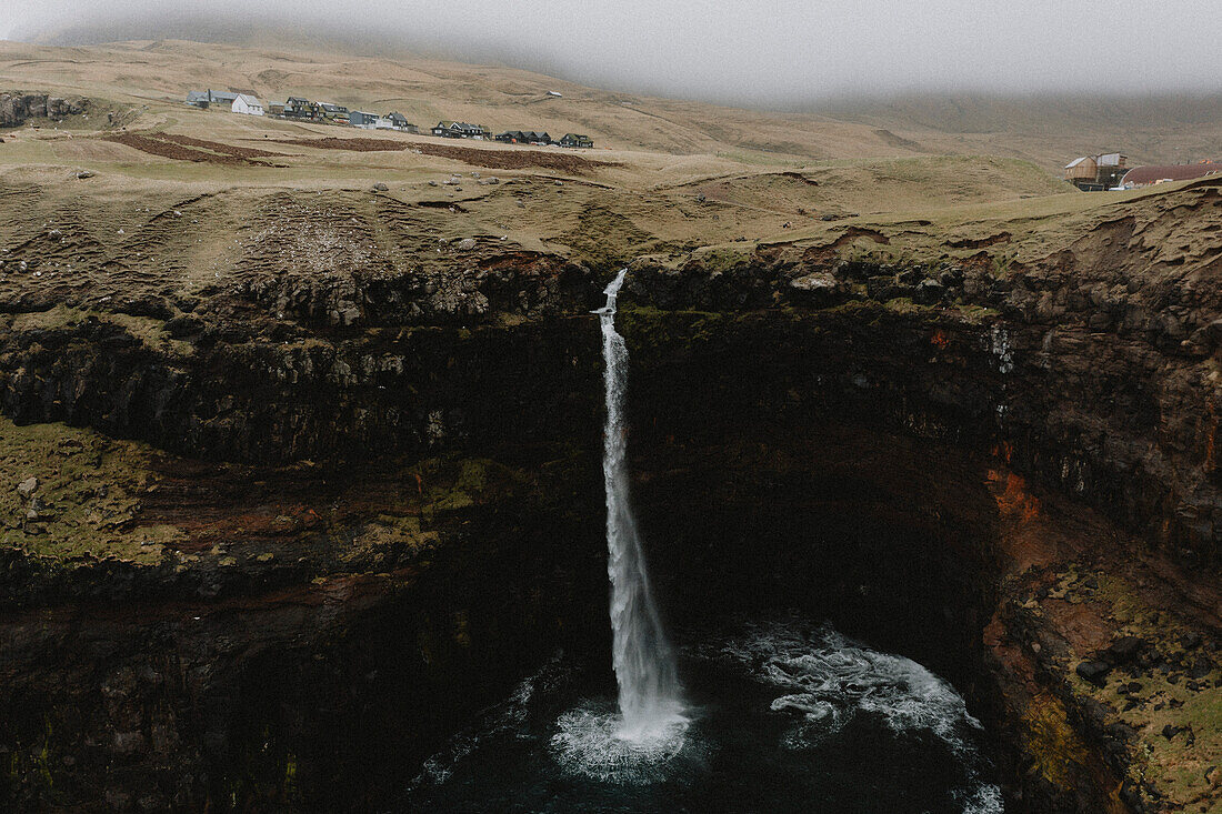 Wasserfall, der über eine Klippe ins Meer fließt, Gasadalur, Vagar, Färöer Inseln