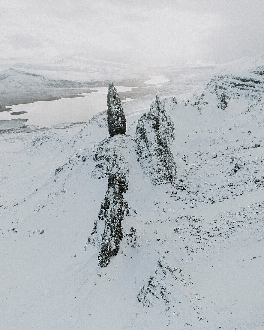 Snow covered mountain rock formation and landscape, Old Man of Storr, Isle of Skye, Scotland\n