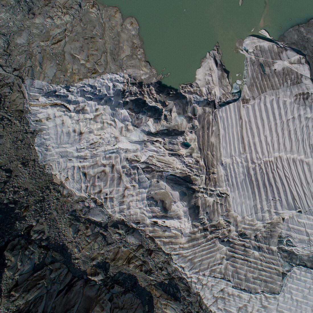 Aerial view textured Rhone Glacier, Canton of Valais, Switzerland\n