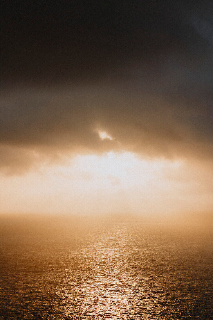 Dramatic sunset sky with clouds over ocean, Neist Point, Isle of Skye, Scotland\n