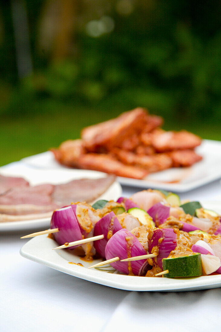Close up of barbeque platter of food on garden table\n