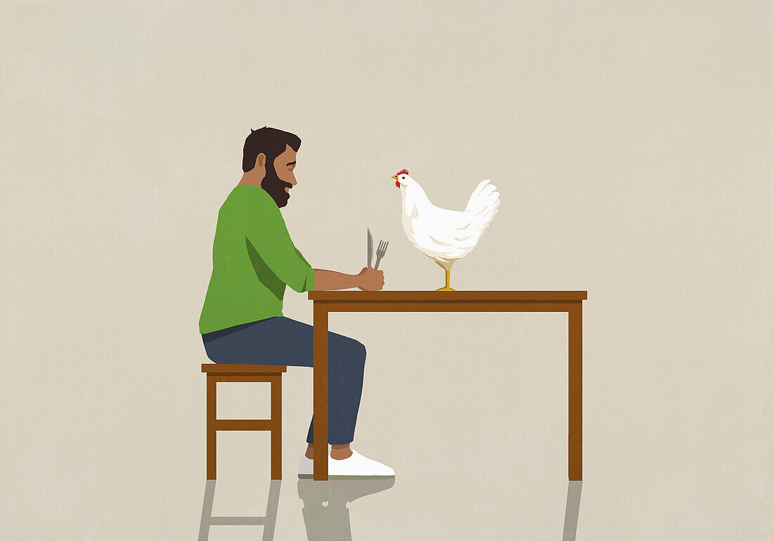 Mann mit Gabel und Messer starrt auf Huhn am Esstisch