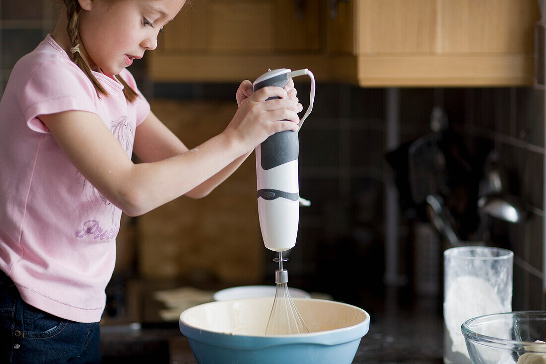 Portrait of young girl whisking\n