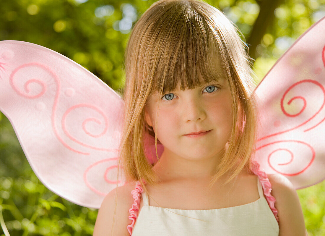 Close up of  girl in a pink fairy costume\n