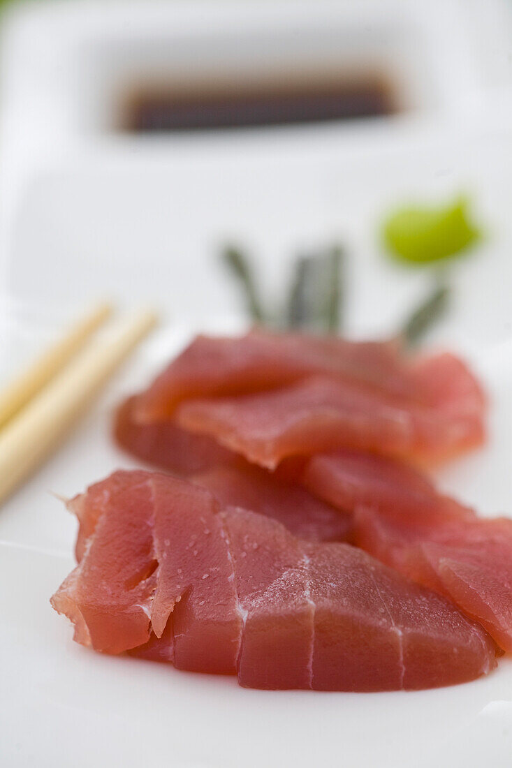 Plate of sushi with sliced tuna fish\n