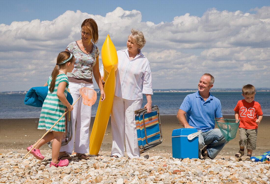 Portrait of multigenerational family leaving beach\n