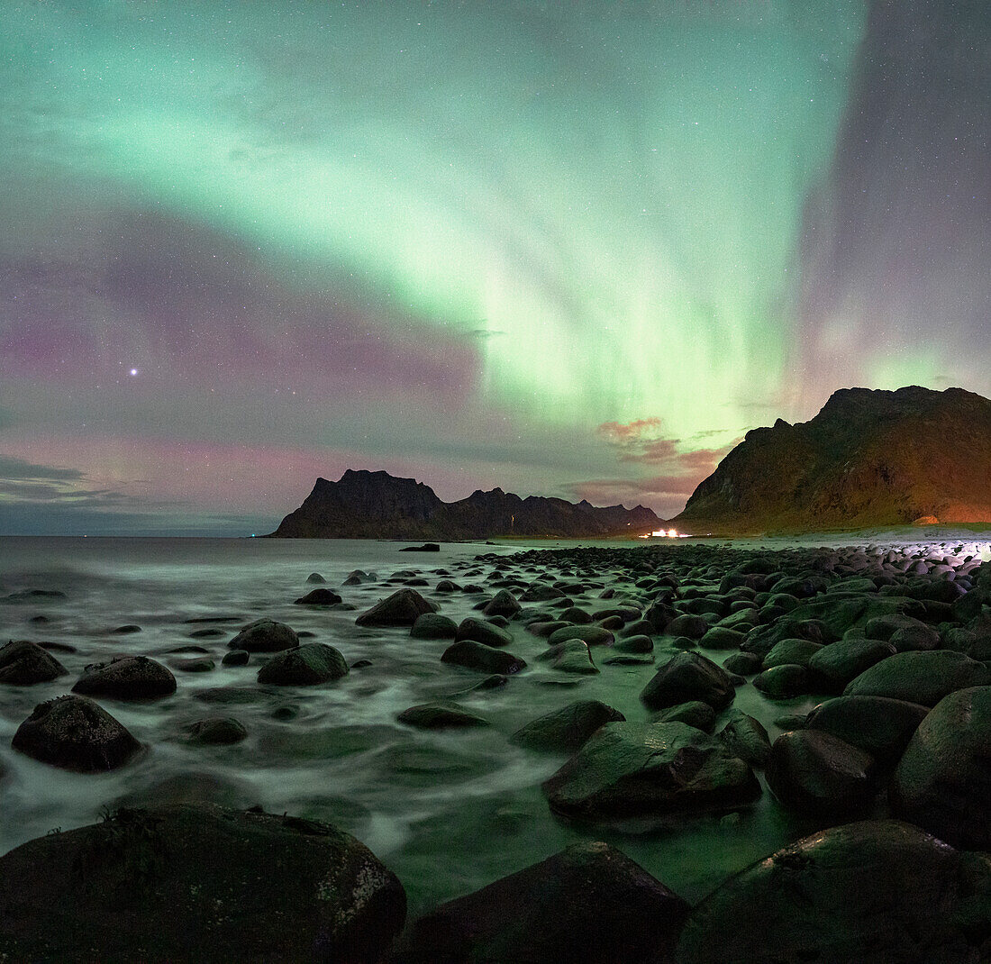 Waves crashing on rocks at Uttakleiv beach under the Aurora Borealis (Northern Lights), Vestvagoy, Lofoten Islands, Nordland, Norway, Scandinavia, Europe\n