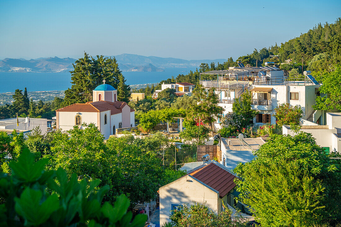 View of Greek Orthodox Church with sea in background, Zia Village, Kos Town, Kos, Dodecanese, Greek Islands, Greece, Europe\n