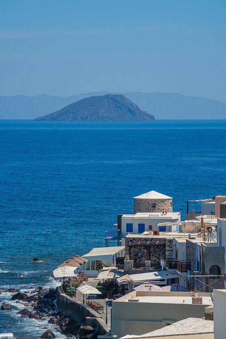 View of sea and whitewashed buildings and rooftops of Mandraki, Mandraki, Nisyros, Dodecanese, Greek Islands, Greece, Europe\n