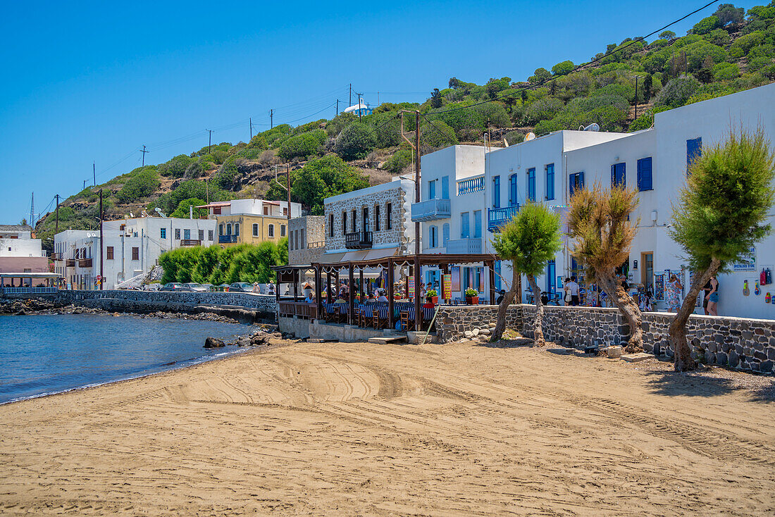 Blick auf kleinen Strand und Geschäfte in der Stadt Mandraki, Mandraki, Nisyros, Dodekanes, Griechische Inseln, Griechenland, Europa