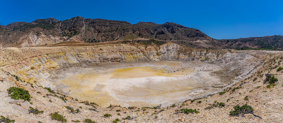 View of visitors exploring the Stefanoskrater Crater, Nisyros, Dodecanese, Greek Islands, Greece, Europe\n