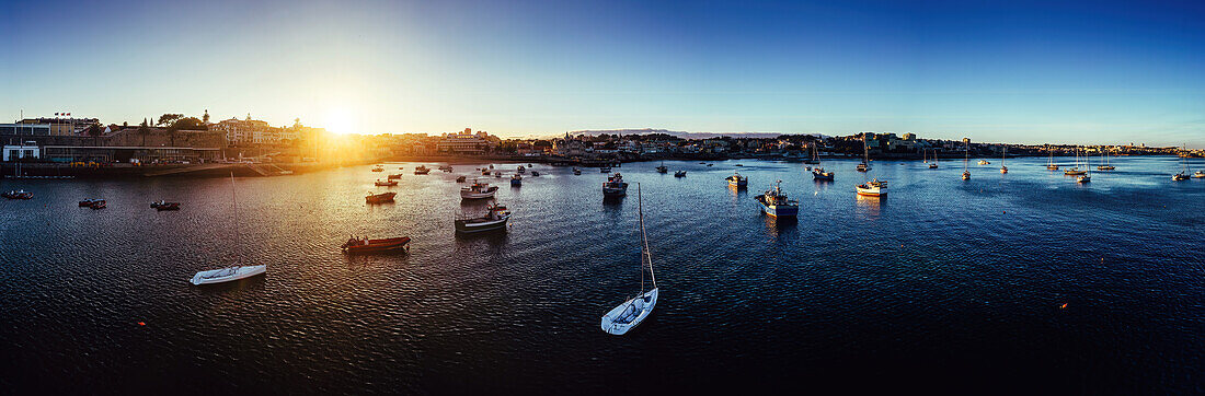 Aerial drone panoramic view of sunset at Cascais Bay, in the Lisbon region of the Portuguese Riveira, Europe\n