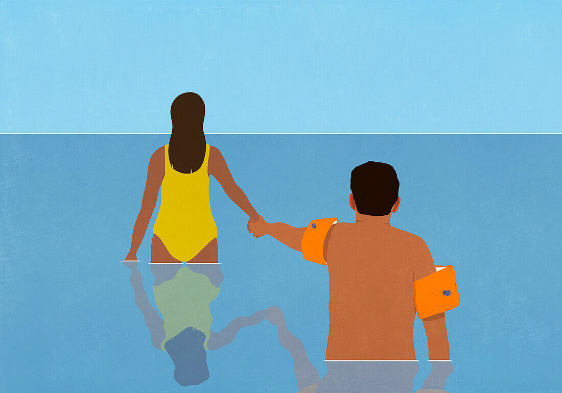 Wife holding hands with hesitant husband in water wings, wading in ocean water\n
