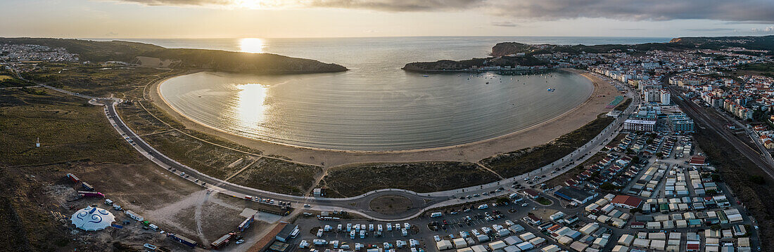 Aerial drone panoramic view at sunset of Sao Martinho do Porto bay, shaped like a scallop with calm waters and fine white sand, Oeste, Portugal, Europe\n