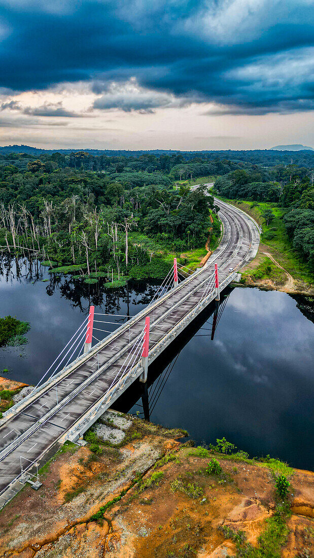 Aerial of a bridge cutting through the jungle to the future capital Ciudad de la Paz, Rio Muni, Equatorial Guinea, Africa\n