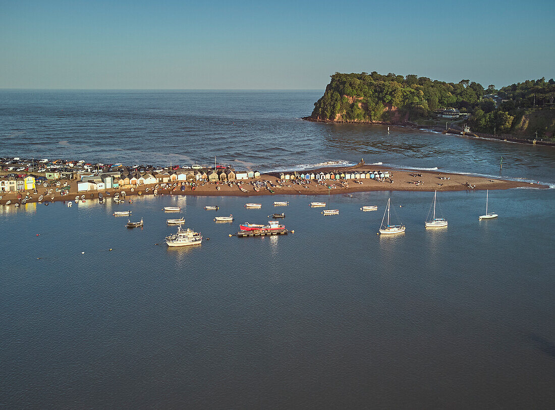 An evening view across the harbour and sandbar in the mouth of the River Teign, looking towards the Ness headland, Teignmouth, on the south coast of Devon, England, United Kingdom, Europe\n