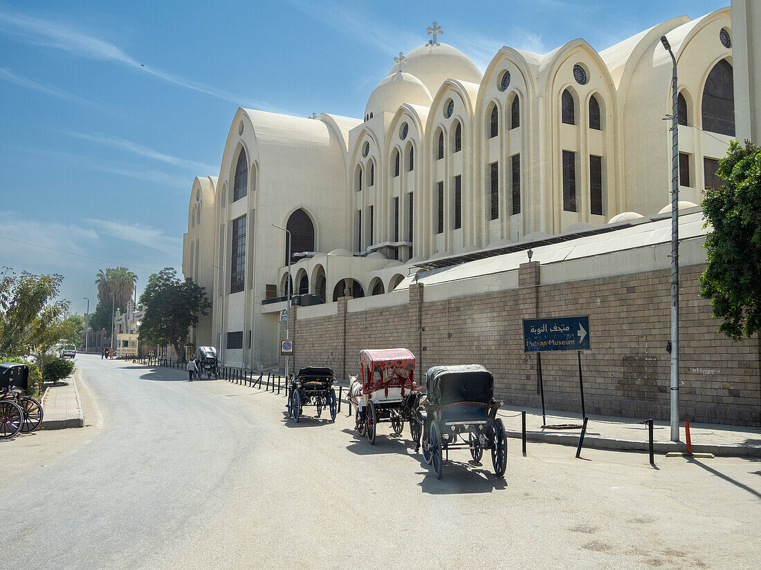 Horse drawn carriages waiting for passengers at the Nubian Museum in the city of Aswan, Egypt, North Africa, Africa\n