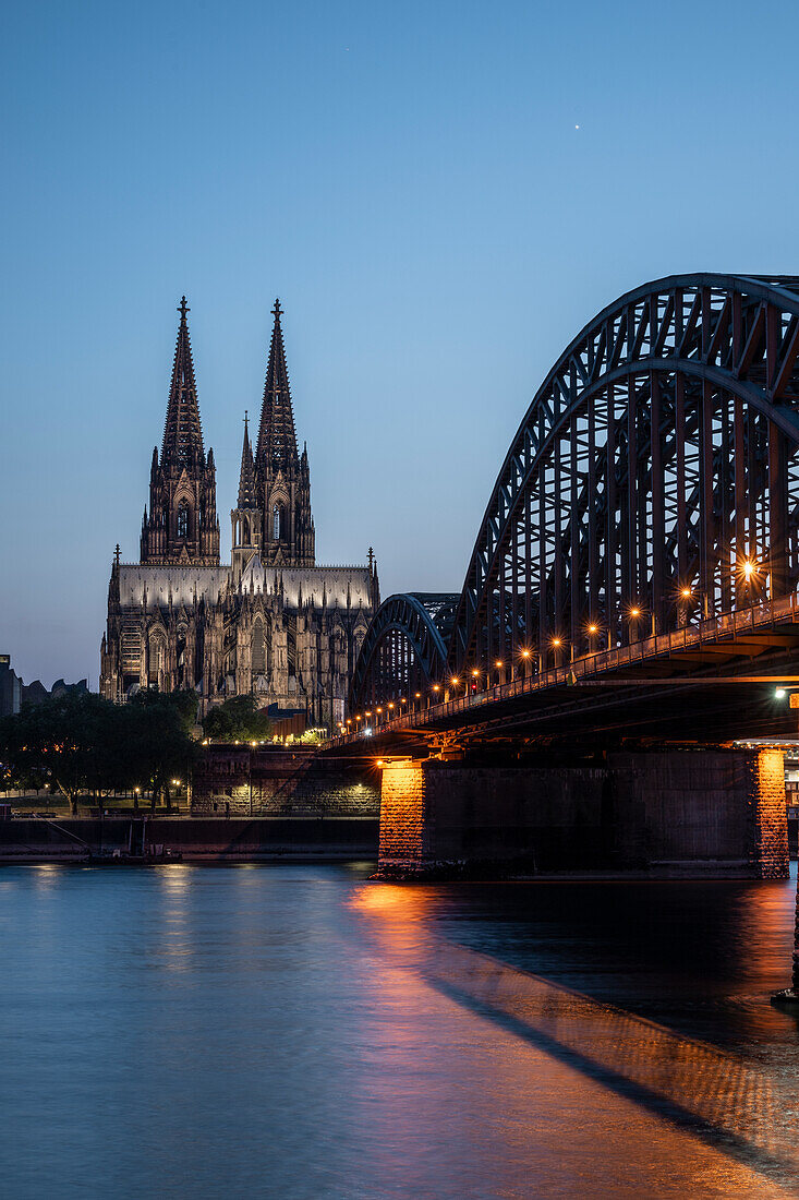 Cologne Cathedral, UNESCO World Heritage Site, and Hohenzollern Bridge at dusk, Cologne, North Rhine-Westphalia, Germany, Europe\n