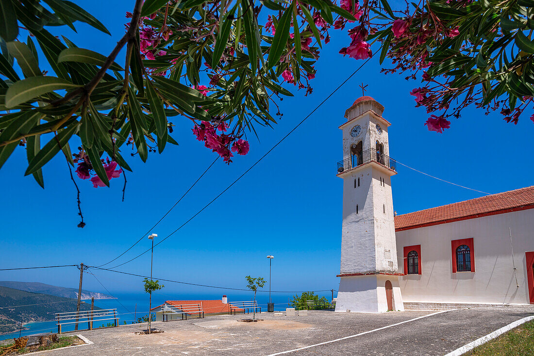 View of church overlooking coastline, sea and hills near Agkonas, Kefalonia, Ionian Islands, Greek Islands, Greece, Europe\n