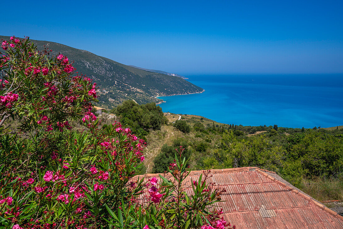 View of houses overlooking coastline, sea and hills near Agkonas, Kefalonia, Ionian Islands, Greek Islands, Greece, Europe\n