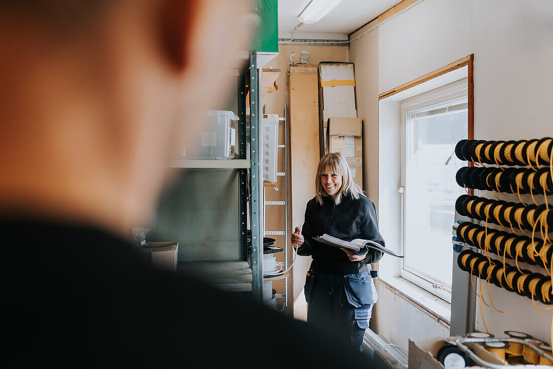 Female worker checking equipment inventory\n