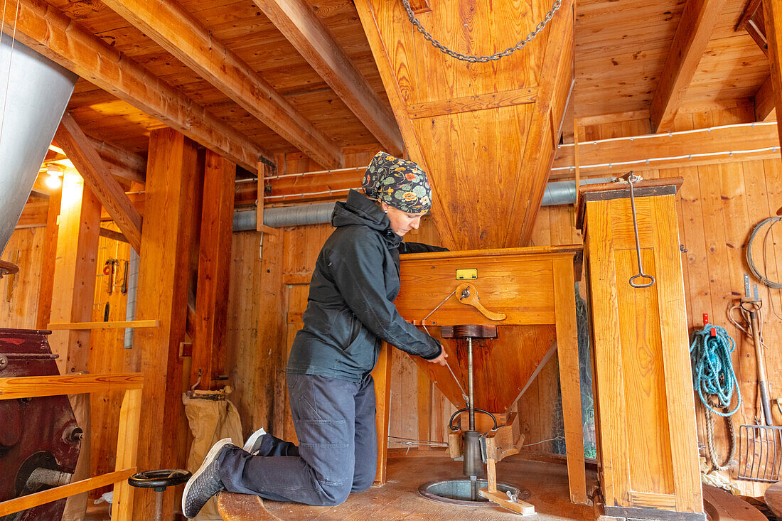 Side view of woman working in flour mill\n