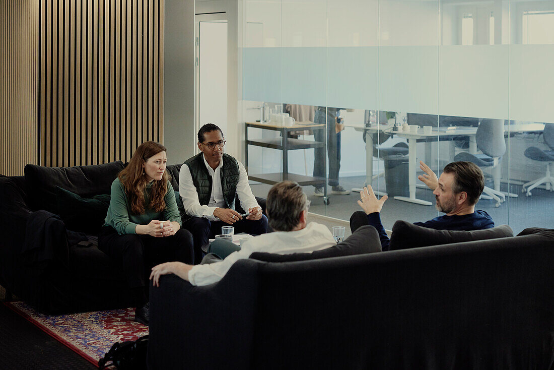 Group of business people having meeting in lobby\n