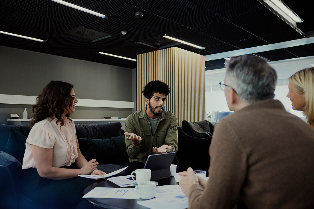 Group of business people having meeting in lobby\n