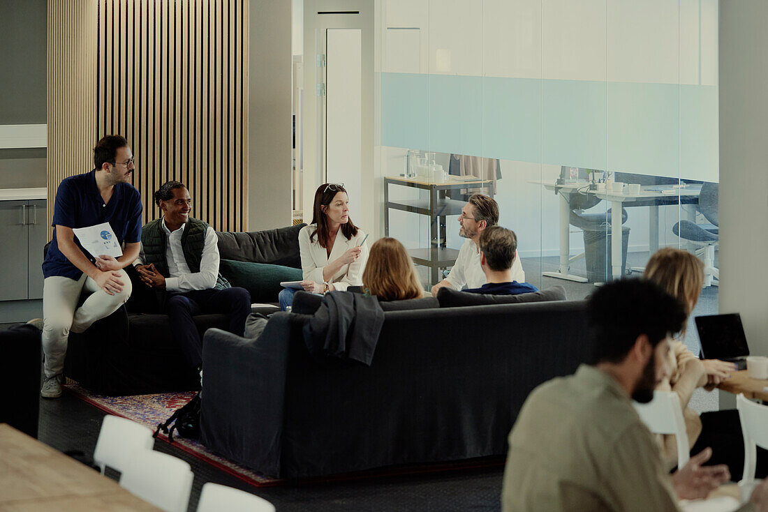 Group of business people having meeting in lobby\n