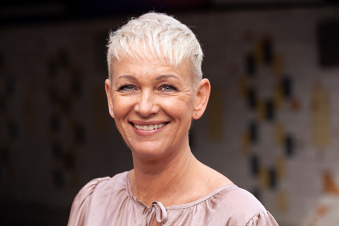 Portrait of smiling mature woman with short hair\n
