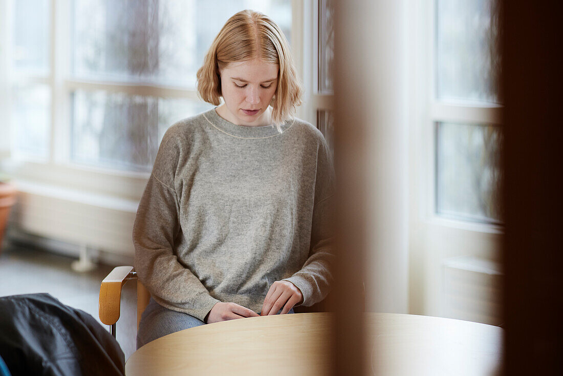 Teenage girl in waiting room looking away\n