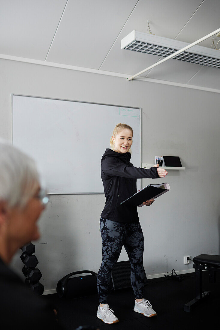 Female coach during presentation in gym\n