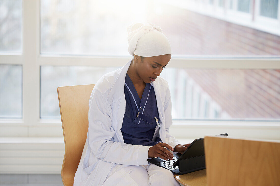 Young female doctor using tablet at work\n