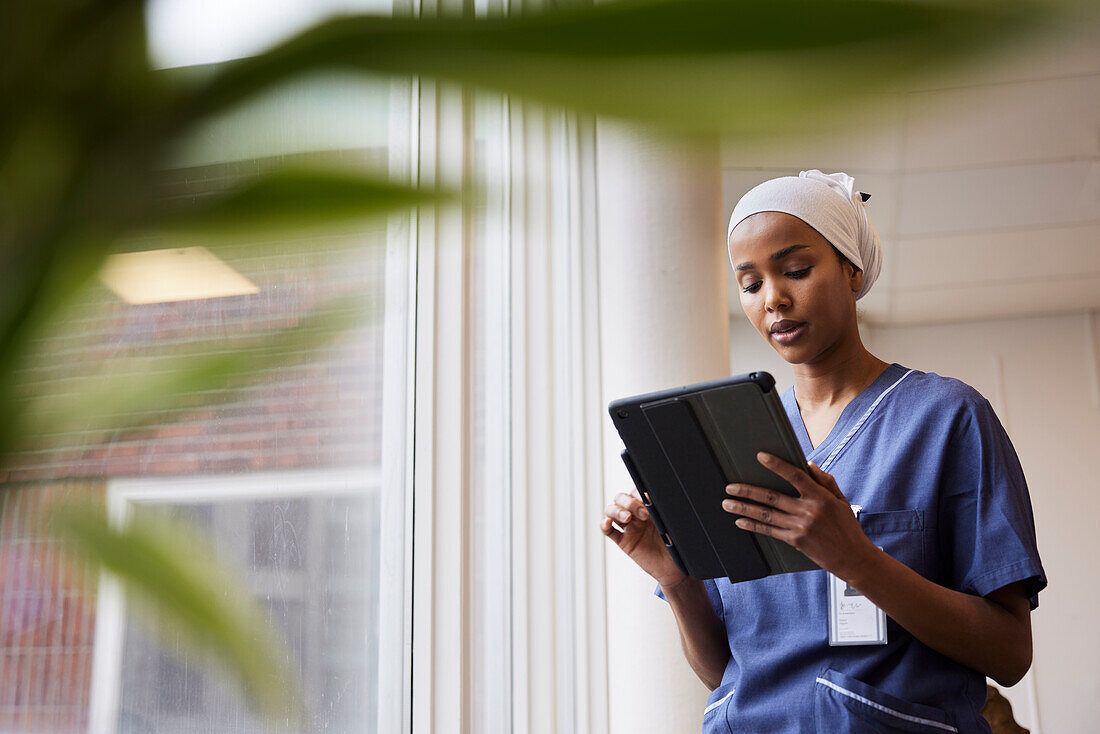 Young female doctor using tablet at work\n