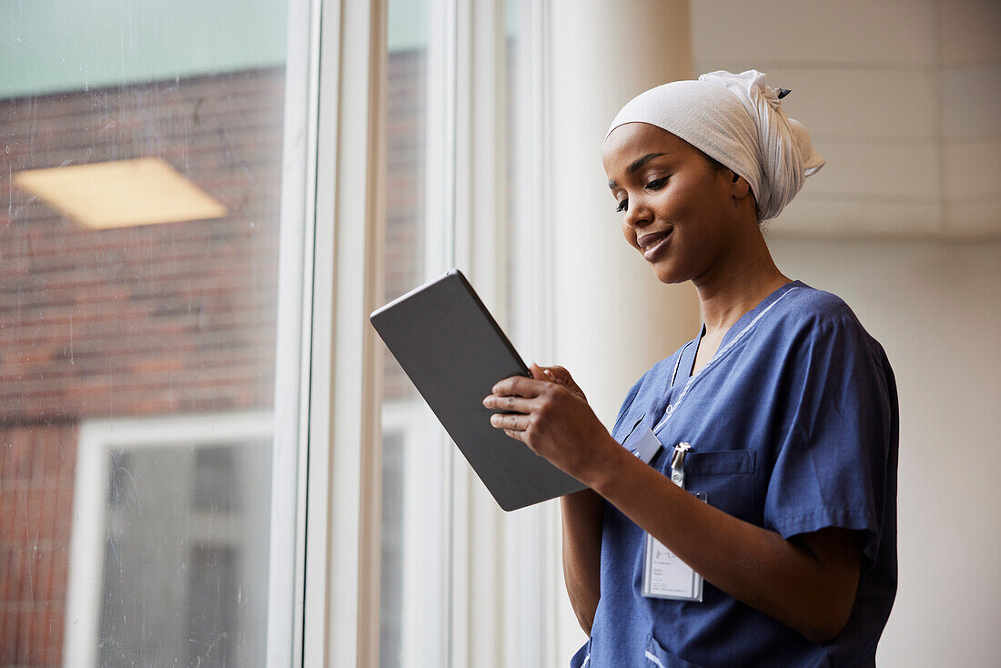 Young female doctor using tablet at work\n