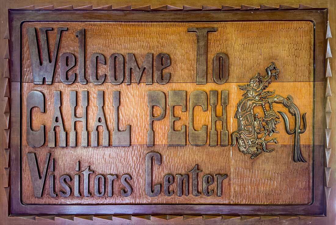 Carved wooden welcome sign for the Visitors Center in the Cahal Pech Archeological Reserve, San Ignacio, Belize.\n