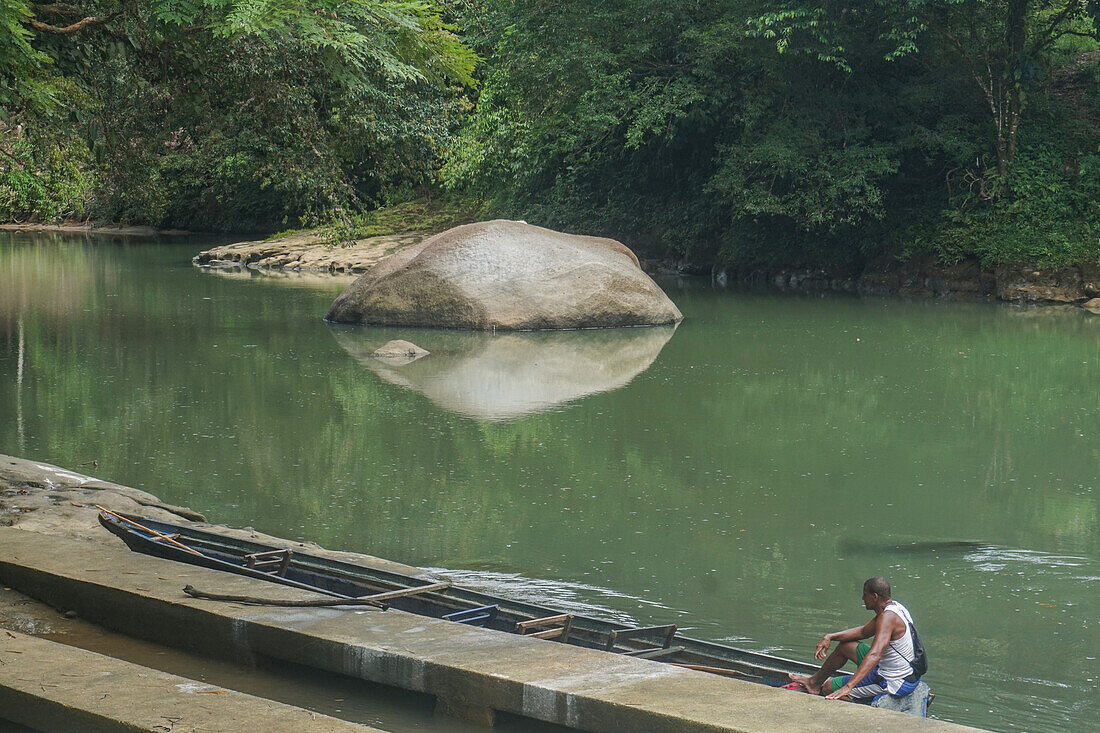 A man sitting in the tourist destination of Quibdo, Tutunendo in Choco, Colombia\n