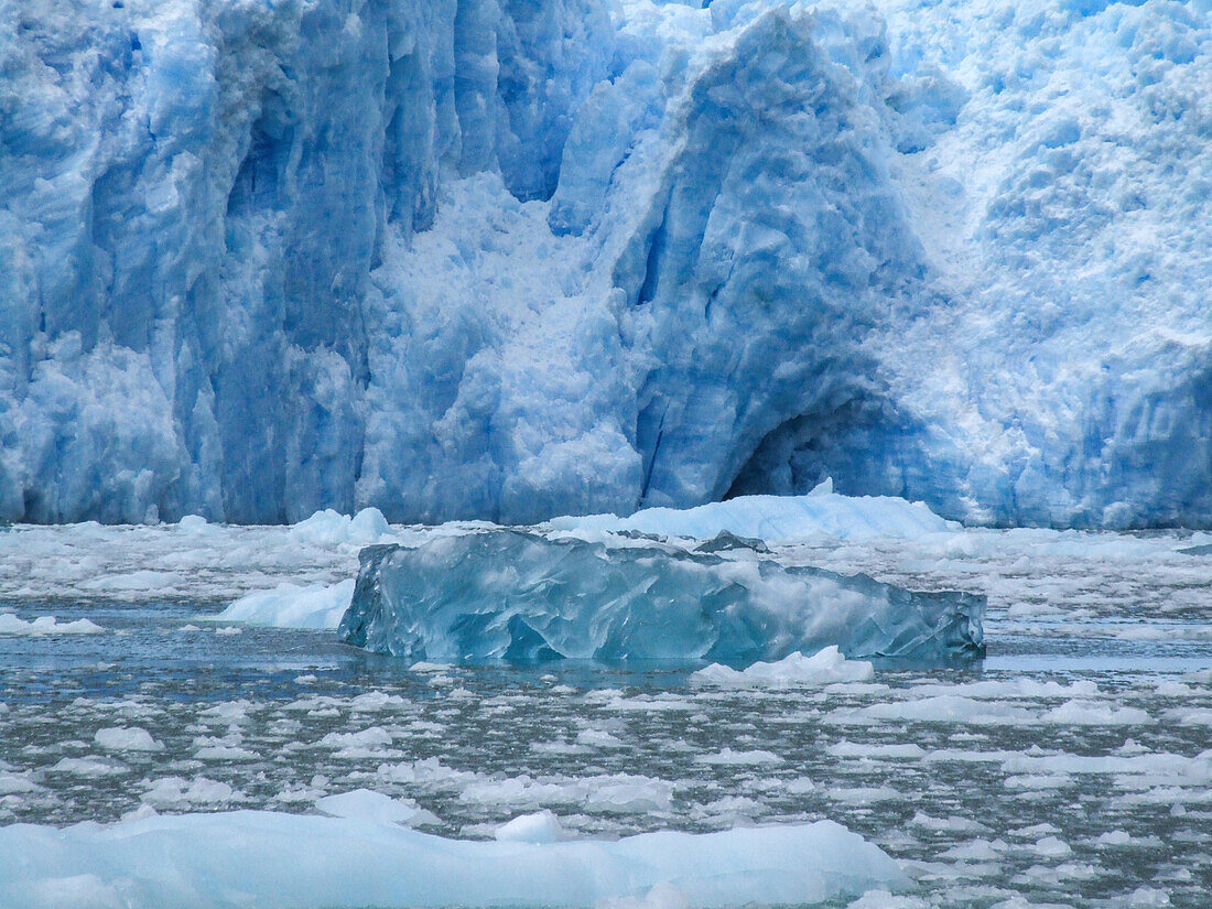 An iceberg of clear ice floats at the terminus of the San Rafael Glacier in Laguna San Rafael National Park, Chile.\n