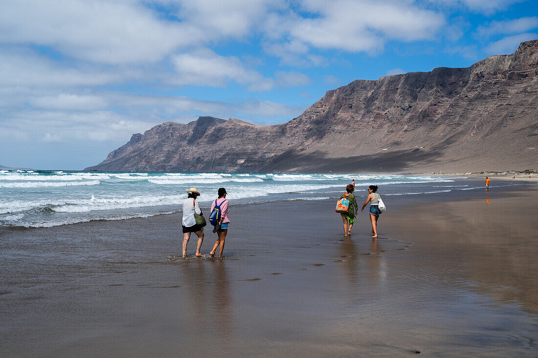 Famara beach (Playa de Famara), 6km golden sand beach located within the Natural Park of the Chinijo Archipelago, between the fishing village of La Caleta de Famara and the base of the impressive cliffs of Famara, Lanzarote, Canary Islands, Spain\n