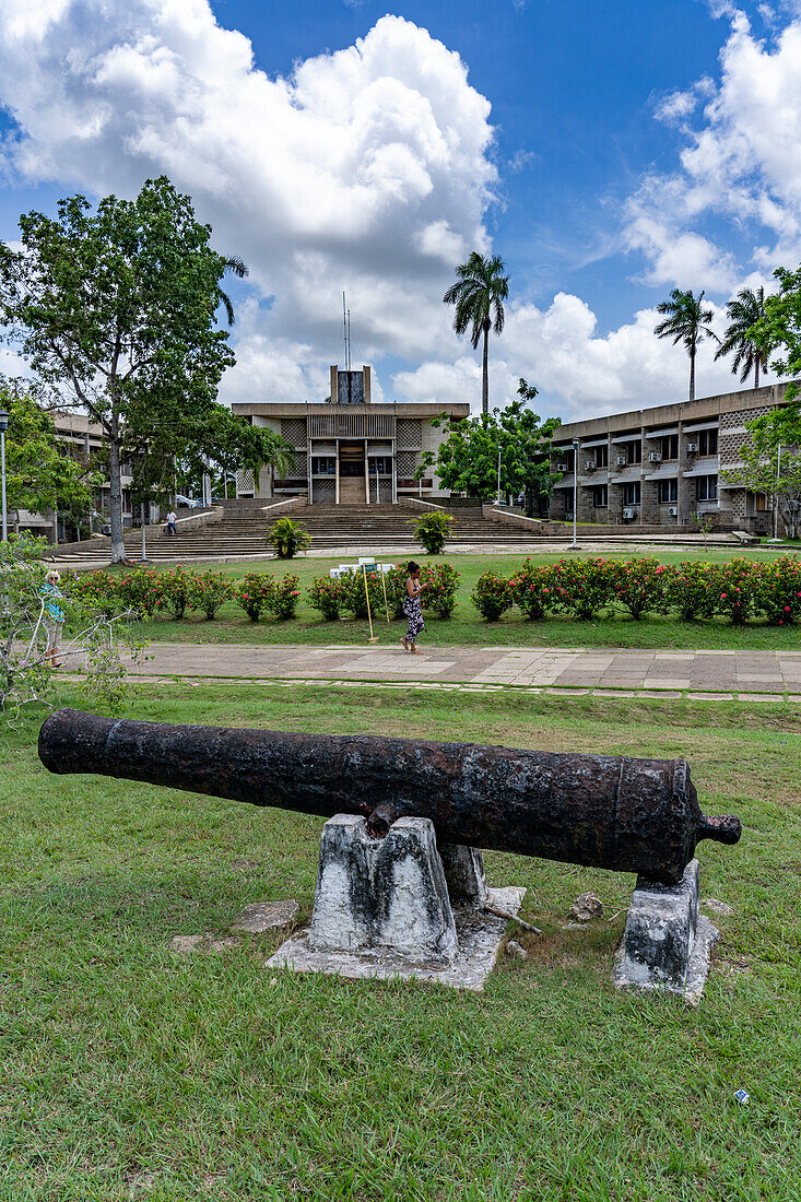 A colonial-era cannon in Independence Plaza in the capital city of Belmopan, Belize. The National Assembly Building is behind.\n