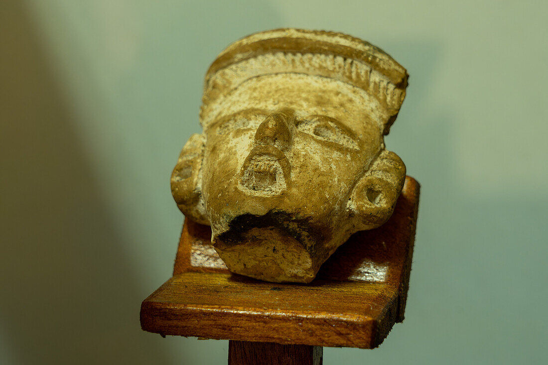 Mayan ceramic figurine in the visitors center museum in the Cahal Pech Archeological Reserve in San Ignacio, Belize.\n