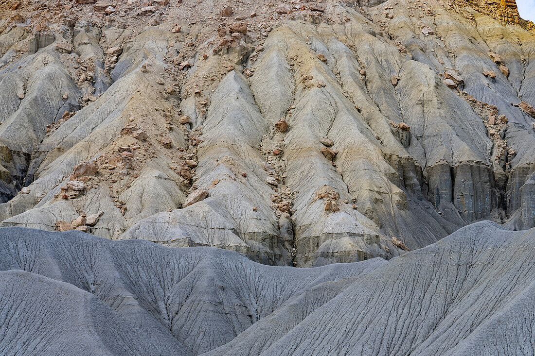 Geometric designs in the erosion patterns of the talus slopes of buttes in the Caineville Desert near Hanksville, Utah.\n