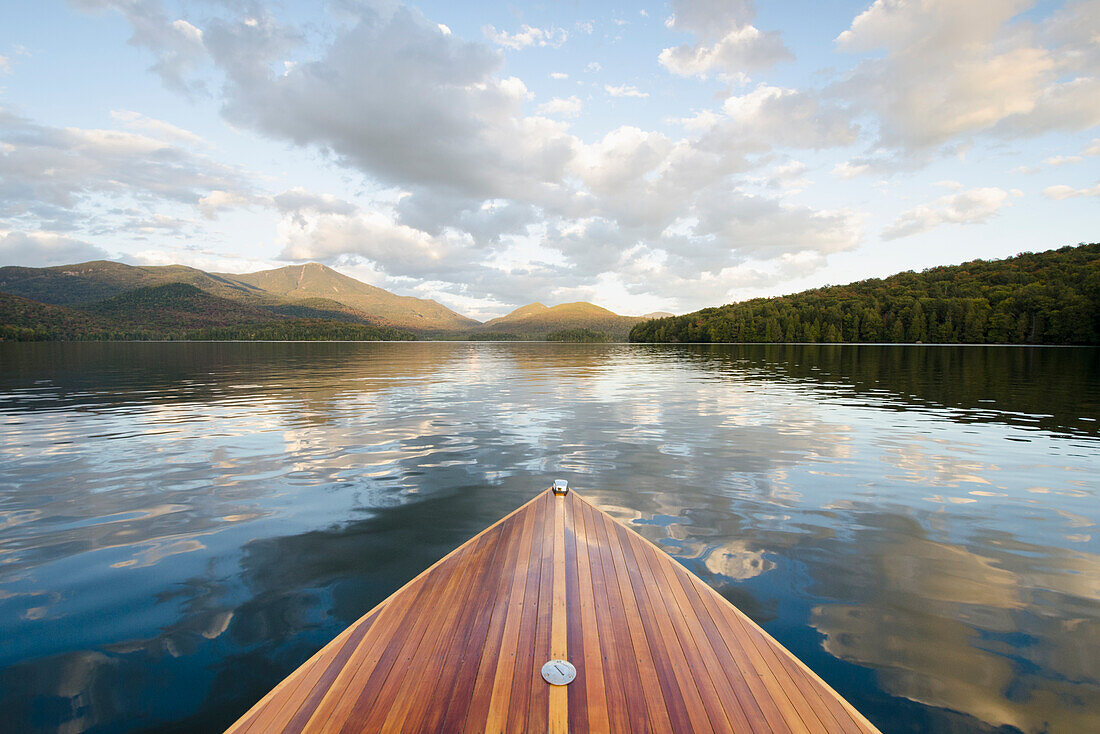 Boat on Lake Placid with Whiteface Mountain in distance\n