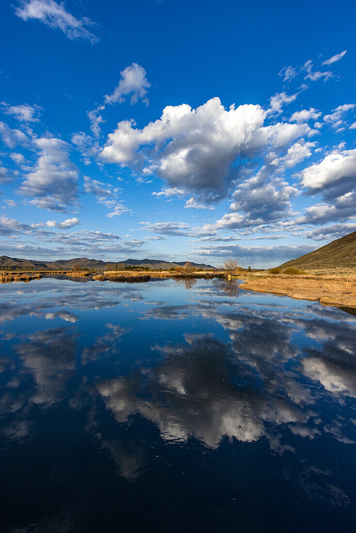 USA, Idaho, Bellevue, Clouds reflecting in lake near Sun Valley\n