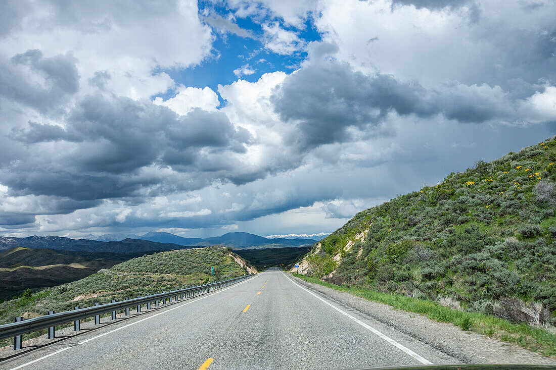 USA, Idaho, Storm clouds gathering above highway\n