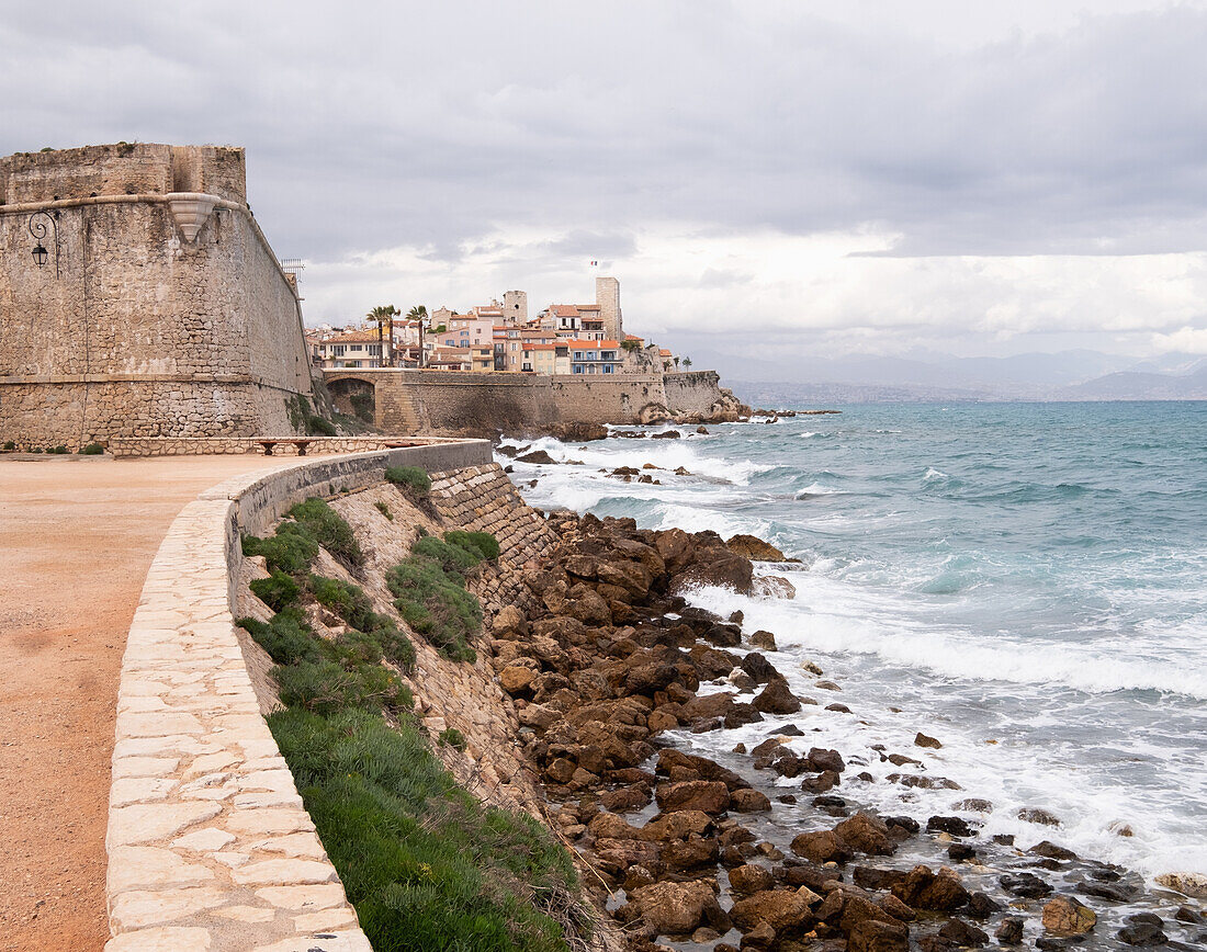 France, Antibes, Coastline and old town by sea\n